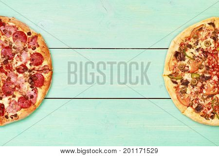 Pizza on wooden. Wooden table top view. On the table are the food for cooking. Healthy food. Dietetic foods. Above view on food. Hot Homemade Pepperoni Pizza Ready to Eat