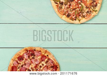 Pizza on wooden. Wooden table top view. On the table are the food for cooking. Healthy food. Dietetic foods. Above view on food. Hot Homemade Pepperoni Pizza Ready to Eat