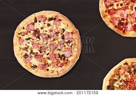 Pizza on wooden table top view. Fast food Delicious. Post blog social media. View from above with copy space. Banner template layout mockup top view on pizza. Pizza ready to eat.