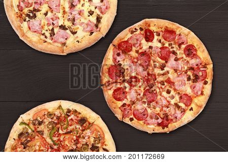 Pizza on wooden table top view. Fast food Delicious. Post blog social media. View from above with copy space. Banner template layout mockup top view on pizza. Pizza ready to eat.