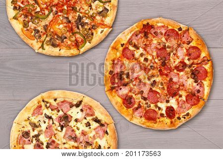 Pizza on wooden table top view. Fast food Delicious. Post blog social media. View from above with copy space. Banner template layout mockup top view on pizza. Pizza ready to eat.
