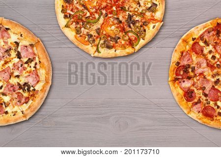 Pizza on wooden table top view. Fast food Delicious. Post blog social media. View from above with copy space. Banner template layout mockup top view on pizza. Pizza ready to eat.