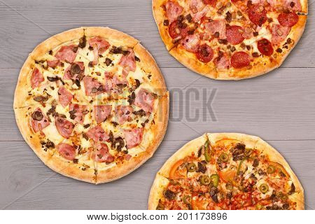 Pizza on wooden table top view. Fast food Delicious. Post blog social media. View from above with copy space. Banner template layout mockup top view on pizza. Pizza ready to eat.