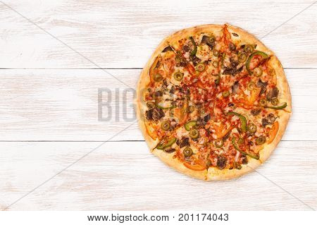 Pizza on wooden table top view. Fast food Delicious. Post blog social media. View from above with copy space. Banner template layout mockup top view on pizza. Pizza ready to eat.
