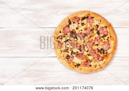 Pizza on wooden table top view. Fast food Delicious. Post blog social media. View from above with copy space. Banner template layout mockup top view on pizza. Pizza ready to eat.
