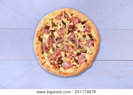 Pizza on wooden table top view. Fast food Delicious. Post blog social media. View from above with copy space. Banner template layout mockup top view on pizza. Pizza ready to eat.