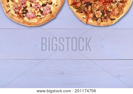 Pizza on wooden table top view. Fast food Delicious. Post blog social media. View from above with copy space. Banner template layout mockup top view on pizza. Pizza ready to eat.