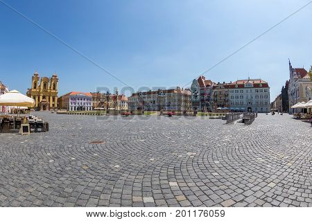 TIMISOARA ROMANIA - AUGUST 24 2017: View of one part at Union Square in Timisoara Romania with old buildings. Trinity Statue german Dom and serbian vicariate in background.