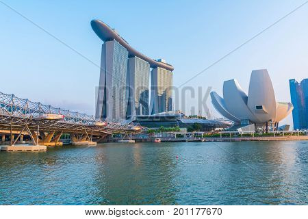 Singapore, Singapore - August 24, 2017: View at the Marina Bay in Singapore during the morning with the iconic landmarks of The Helix Bridge.