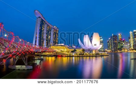 Singapore, Singapore - August 24, 2017: View at the Marina Bay in Singapore during the night with the iconic landmarks of The Helix Bridge.
