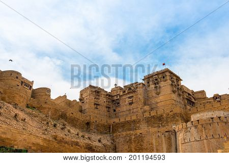 Upward picture of Jaisalmer Fort carved yellow sandstone architecture in Jaisalmer known as Golden City in India.
