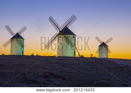 Illumintaed traditional windmills at rising Campo de Criptana Spain