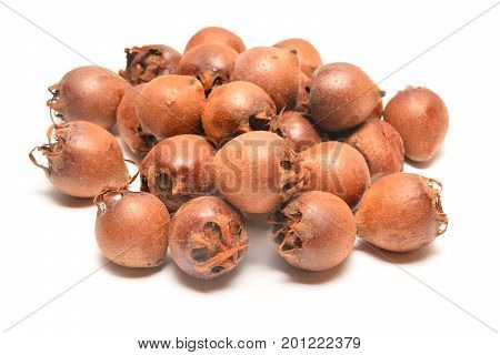 pile of medlar fruits isolated on white background