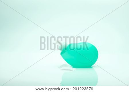 Nasal irrigation equipment Green nose cleansing device with hypertonic solution on white background with copy space just add your own text