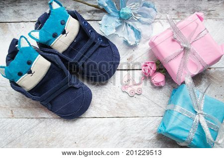 Little girlie baby shoes on a wood