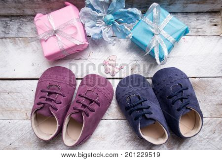 Little girlie baby shoes on a wood