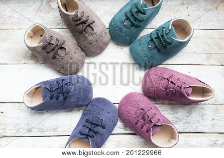 Little girlie baby shoes on a wood