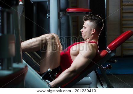 The man in the red shirt is at the gym horizontal