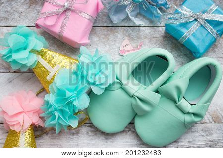 Little girlie baby shoes on a wood