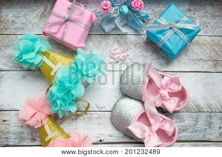 Little girlie baby shoes on a wood