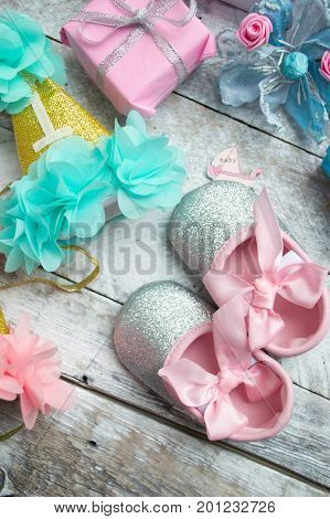 Little girlie baby shoes on a wood