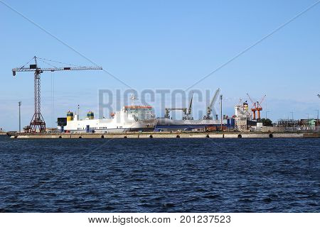 A cargo ship docked at the port of Dunkirk occupied to be loaded by cranes