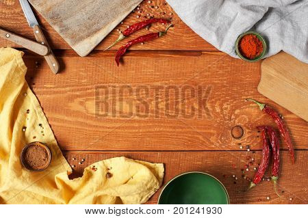 Wooden background with kitcen utensils and spices