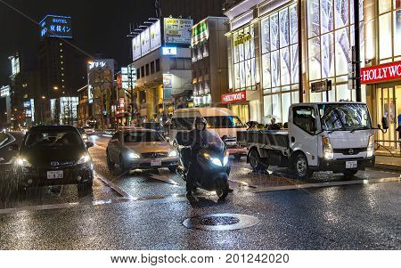 JAPAN, TOKYO, APRIL, 02, 2017 - Night traffic on the streets of Tokyo near Shinagawa Station during the rain. Shinagawa-eki is a major railway station in Tokyo, Japan.
