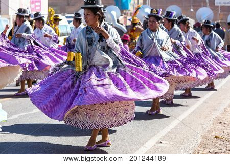PUNO, PERU - AUGUST 07: Authentic Colorful Carnival on the streets of Puno, Peru near the high altutude Titicaca lake on August 7th, 2017