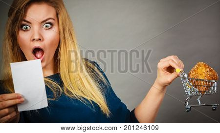 Shocked Woman Holding Shopping Basket With Bread