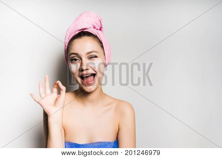 Woman with mask under eye on white