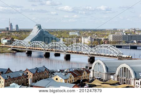 LATVIA, RIGA, APRIL, 25, 2015 -  Panorama view of Riga city, capital of Latvia. View of the railway bridge over the Daugava river, library and central market in Riga, Latvia