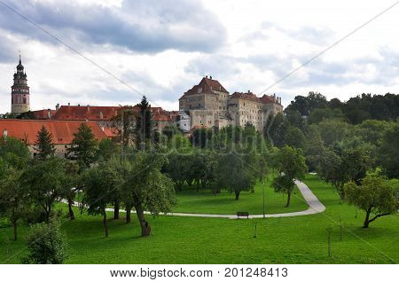 Unusual view of Cesky Krumlov with trees and park ancient historical beautiful UNESCO town Czech republic