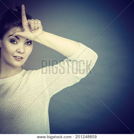 Woman Showing Loser Gesture With L On Forehead