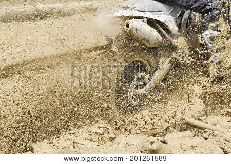 Motocross accelerating  speed  in muddy track .