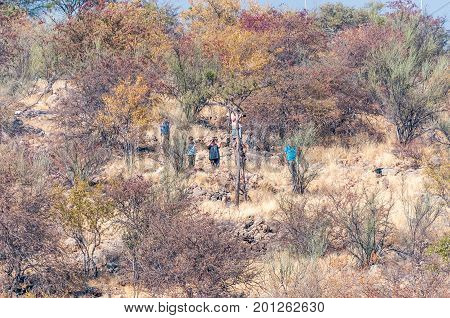 ETOSHA NATIONAL PARK NAMIBIA - JUNE 27 2017: Unidentified tourists at the viewpoint in the Dolomite Rest Camp in the western part of the Etosha National Park