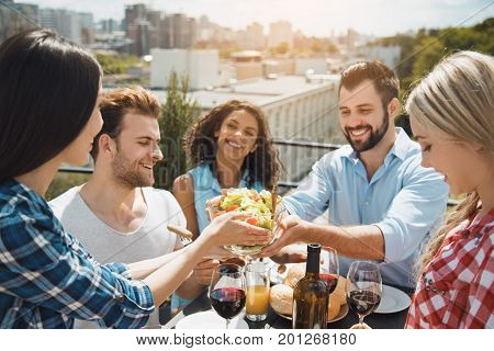 Group of people having barbecue party eating