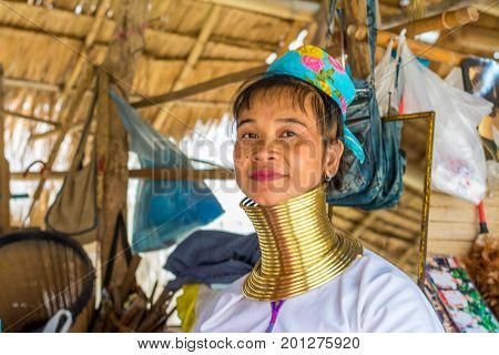 CHIANG MAI, THAILAND - July 10, 2017: Karen hill-tribe (Long Neck) woman weaving fabrics for a living at her house.