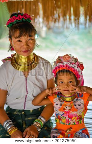 CHIANG MAI, THAILAND - July 10, 2017: Karen hill-tribe (Long Neck) woman weaving fabrics for a living at her house.