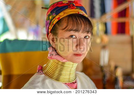 CHIANG MAI, THAILAND - July 10, 2017: Karen hill-tribe (Long Neck) woman weaving fabrics for a living at her house.