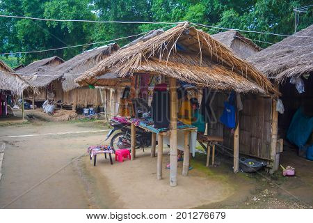 CHIANG MAI, THAILAND - July 10, 2017: Karen hill-tribe (Long Neck) woman weaving fabrics for a living at her house.