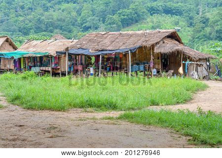CHIANG MAI, THAILAND - July 10, 2017: Karen hill-tribe (Long Neck) woman weaving fabrics for a living at her house.