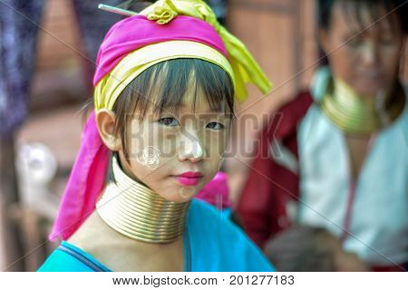CHIANG MAI, THAILAND - July 10, 2017: Karen hill-tribe (Long Neck) woman weaving fabrics for a living at her house.
