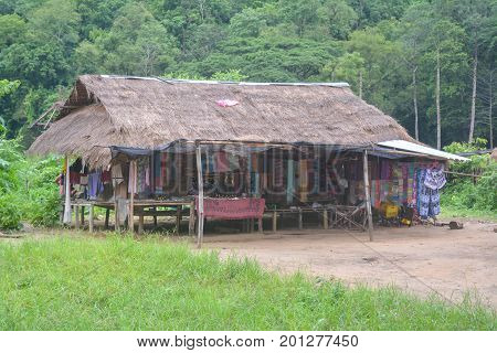 CHIANG MAI, THAILAND - July 10, 2017: Karen hill-tribe (Long Neck) woman weaving fabrics for a living at her house.