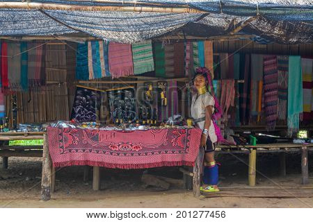 CHIANG MAI, THAILAND - July 10, 2017: Karen hill-tribe (Long Neck) woman weaving fabrics for a living at her house.