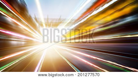 Foward motion speed lens blur racing circuit background with seated stand and light trail effect .