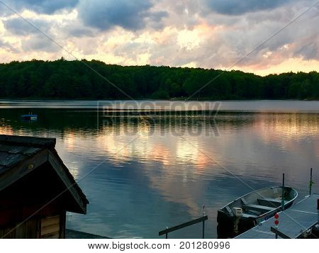 Peaceful soft colors of sunset reflect on intimate lake