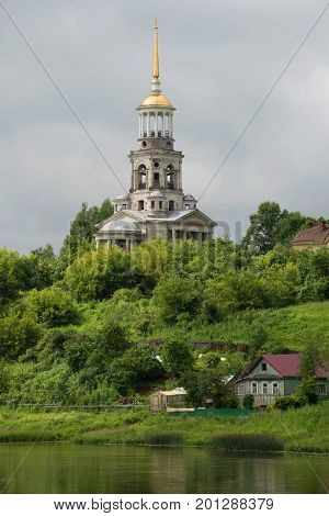 Bell tower of the Borisoglebskii monastery closeup cloud. July afternoon. Torzhok, Russia