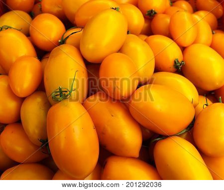fresh orange tomatoes lying in a box.