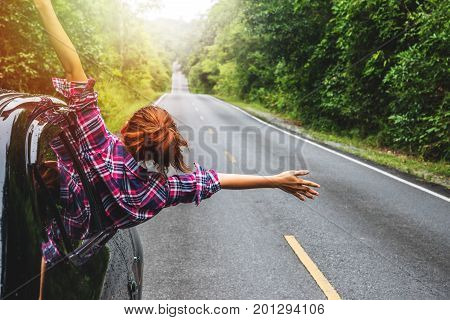 Asian women travel relax in the holiday. driving a car traveling happily.